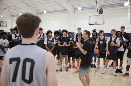 Bobby coaching a full gym of players at a camp