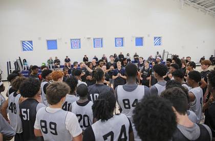 Bobby addressing a large group of high school players